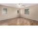 Spacious bedroom with laminated floors, neutral walls, ceiling fan and lots of natural light from three windows at 10 N 87Th Dr, Tolleson, AZ 85353