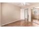Bedroom boasts laminate flooring, ceiling fan and large closet with mirror at 10 N 87Th Dr, Tolleson, AZ 85353