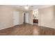 Light-filled bedroom featuring stylish laminated floors, a ceiling fan, and an ensuite bathroom with vanity at 10 N 87Th Dr, Tolleson, AZ 85353