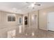 Bright and airy living room with tile flooring and an open archway leading to the kitchen at 10 N 87Th Dr, Tolleson, AZ 85353