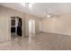 Spacious living area featuring tile floors and an open floor plan leading to the kitchen at 10 N 87Th Dr, Tolleson, AZ 85353