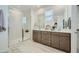 Modern bathroom featuring a glass-enclosed shower, double vanity, and neutral color scheme at 10049 E Ulysses Ave, Mesa, AZ 85212