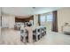 Dining area with a modern table and chairs set, open to the kitchen and living spaces at 10049 E Ulysses Ave, Mesa, AZ 85212
