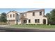 Charming two-story home with neutral stucco, tile roof, landscaped front yard, and an attached two-car garage at 10049 E Ulysses Ave, Mesa, AZ 85212