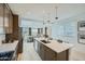 Spacious kitchen with stainless appliances, white countertops, dark wood cabinets, and an open view to the dining and living area at 10049 E Ulysses Ave, Mesa, AZ 85212