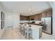 Modern kitchen with stainless steel appliances, island with seating, pendant lighting, and white countertops at 10049 E Ulysses Ave, Mesa, AZ 85212
