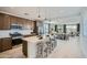 Open-concept kitchen featuring a large island with seating and pendant lighting, connecting to the dining and living spaces at 10049 E Ulysses Ave, Mesa, AZ 85212