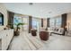 Bright and airy living room with neutral tones, tile floors, large windows, modern furnishings, and outdoor access at 10049 E Ulysses Ave, Mesa, AZ 85212