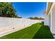 Backyard features manicured lawn, a concrete wall, and lush landscaping at 10156 E Talon Ave, Mesa, AZ 85212