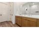 Bathroom featuring double sinks, a walk-in shower, and modern wood cabinets at 10156 E Talon Ave, Mesa, AZ 85212