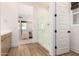 Bright bathroom featuring glass shower, wood-look floors, and modern vanity at 10156 E Talon Ave, Mesa, AZ 85212