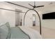 Bright primary bedroom features a black ceiling fan, four-poster bed, and white walls at 10156 E Talon Ave, Mesa, AZ 85212