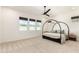 Spacious bedroom with neutral tones, large windows, and a four-poster bed frame at 10156 E Talon Ave, Mesa, AZ 85212