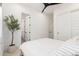 Bright bedroom features a ceiling fan and decorative tree in a neutral color palette at 10156 E Talon Ave, Mesa, AZ 85212