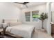 Inviting bedroom with large windows, a decorative plant, and neutral color scheme at 10156 E Talon Ave, Mesa, AZ 85212