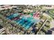 Aerial view of a resort-style community pool with colorful water slides and lounge seating at 10156 E Talon Ave, Mesa, AZ 85212