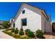 New construction white exterior home with lush landscaping at 10156 E Talon Ave, Mesa, AZ 85212