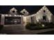 Gorgeous new construction home exterior at night features white paint and a two-car garage at 10156 E Talon Ave, Mesa, AZ 85212