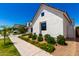 New construction white exterior home with lush landscaping at 10156 E Talon Ave, Mesa, AZ 85212