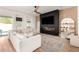 Beautiful living room with hardwood floors, fireplace, and modern decor at 10156 E Talon Ave, Mesa, AZ 85212