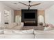 Modern living room features a fireplace, television, ceiling fan, and white sofa at 10156 E Talon Ave, Mesa, AZ 85212