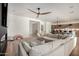 Bright living room with hardwood floors, modern fan, and open floor plan at 10156 E Talon Ave, Mesa, AZ 85212