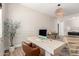 Bright home office features a stylish desk, wood floors, and decorative wainscoting at 10156 E Talon Ave, Mesa, AZ 85212