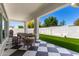 Spacious covered patio offering views of the backyard, grill, and lush landscaping at 10156 E Talon Ave, Mesa, AZ 85212