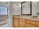 Bathroom with double sink vanity and tiled shower with glass block window at 10235 N 31St St # 15, Phoenix, AZ 85028