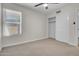 Bright bedroom features neutral carpet, ceiling fan, a window and closet at 10235 N 31St St # 15, Phoenix, AZ 85028