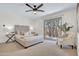 Comfortable bedroom with a plush bed, a ceiling fan, and sliding glass doors to the outside at 10235 N 31St St # 15, Phoenix, AZ 85028