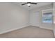 Bedroom with neutral carpeting, window, closet, and ceiling fan at 10235 N 31St St # 15, Phoenix, AZ 85028