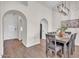 Elegant dining room featuring stylish furniture, wood floors, and arched doorways at 10235 N 31St St # 15, Phoenix, AZ 85028