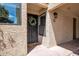 Close-up of the front door with a decorative wreath and a 'hello' doormat at 10235 N 31St St # 15, Phoenix, AZ 85028