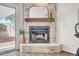 Modern fireplace with stone surround, a wooden mantle, and decorative mirror at 10235 N 31St St # 15, Phoenix, AZ 85028