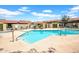 Community pool and deck featuring multiple seating areas and umbrellas at 10235 N 31St St # 15, Phoenix, AZ 85028