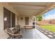 Back patio featuring chairs and bench with landscaped yard and block fencing at 1130 W Kingbird Dr, Chandler, AZ 85286
