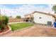 Lush green backyard offering a serene outdoor space with garden beds and a covered patio area, complete with desert landscaping at 1130 W Kingbird Dr, Chandler, AZ 85286