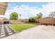 Spacious backyard featuring a well-maintained lawn, decorative rock landscaping, and a sturdy brick perimeter at 1130 W Kingbird Dr, Chandler, AZ 85286