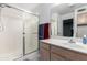 Well-lit bathroom featuring a glass shower, neutral cabinet, and updated sink at 1130 W Kingbird Dr, Chandler, AZ 85286