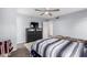 Bedroom featuring gray walls, wood-look flooring, and a neutral ceiling fan at 1130 W Kingbird Dr, Chandler, AZ 85286