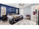 This primary bedroom has an ensuite bathroom, neutral colored walls, and a ceiling fan at 1130 W Kingbird Dr, Chandler, AZ 85286