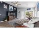 Comfortable living room featuring a large sectional sofa, ceiling fan, and stylish decor at 1130 W Kingbird Dr, Chandler, AZ 85286