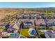 Beautiful aerial view showcasing the home's backyard with pool, landscaping, and surrounding neighborhood at 11844 W Nadine Way, Peoria, AZ 85383