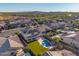 Stunning aerial view of the home featuring a pool, spa, solar panels and well-manicured landscaping at 11844 W Nadine Way, Peoria, AZ 85383