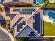 Aerial view showcasing solar panels, a well-maintained roof, and lush green lawn at 11844 W Nadine Way, Peoria, AZ 85383