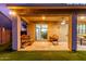 Inviting back patio with sitting area that leads to the open sliding door with additional dining in the background at 11844 W Nadine Way, Peoria, AZ 85383