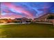 Spacious backyard with lush artificial turf, sparkling pool with waterfall feature, and ample room for recreation at 11844 W Nadine Way, Peoria, AZ 85383
