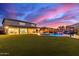 Expansive backyard with lush turf, a sparkling pool with waterfall, and a covered patio for outdoor entertaining at 11844 W Nadine Way, Peoria, AZ 85383