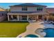 Expansive backyard with patio, fire pit, synthetic lawn, and private pool with spa at 11844 W Nadine Way, Peoria, AZ 85383